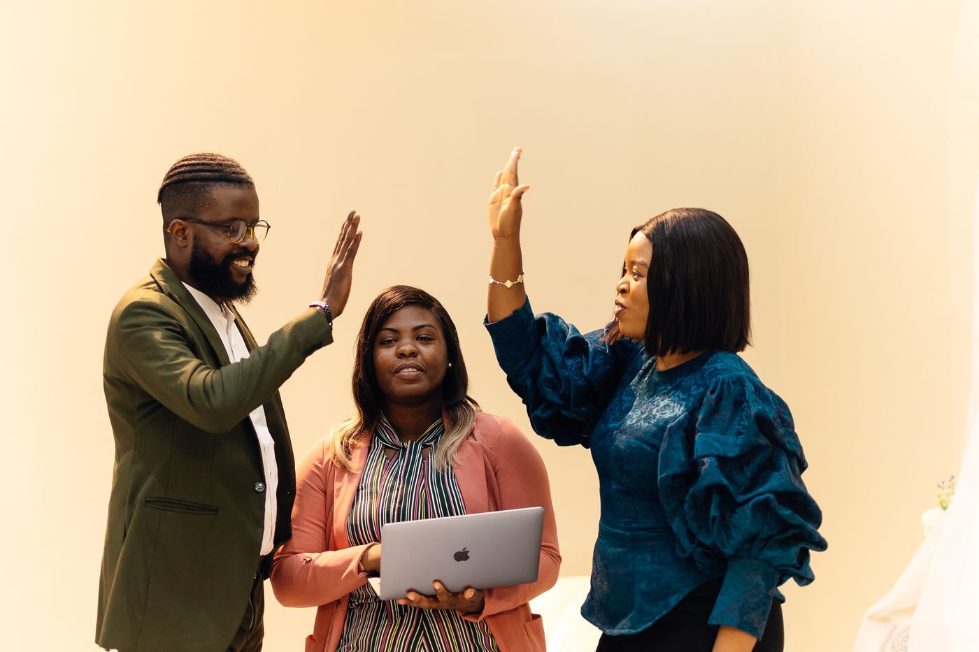 Colleagues celebrating a successful project in a Lagos office